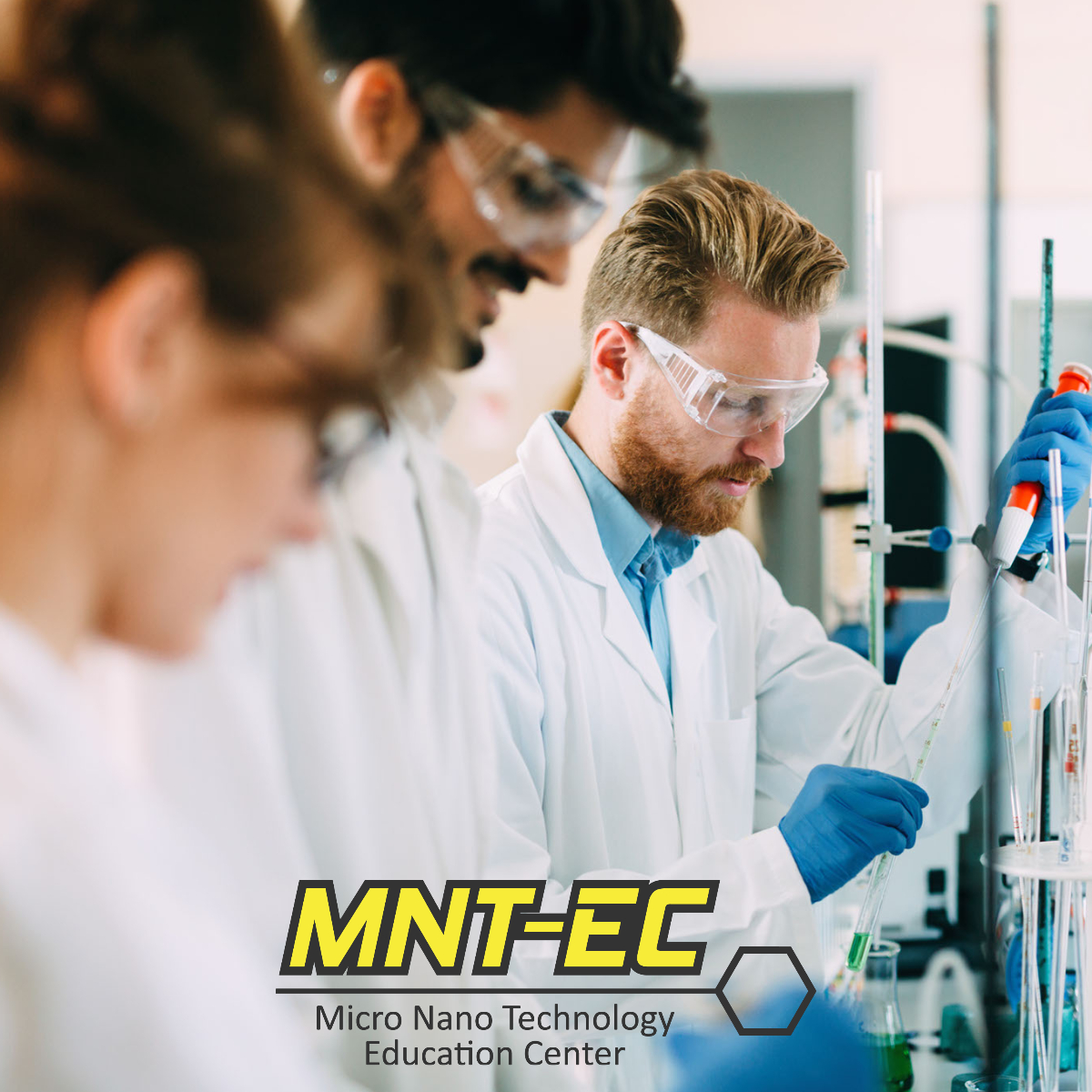 a group working in a lab with the MNTEC logo
