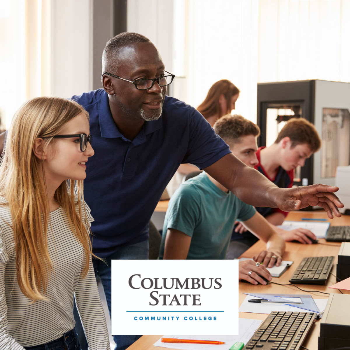 Image of teacher in computer lab with columbus state community college logo
