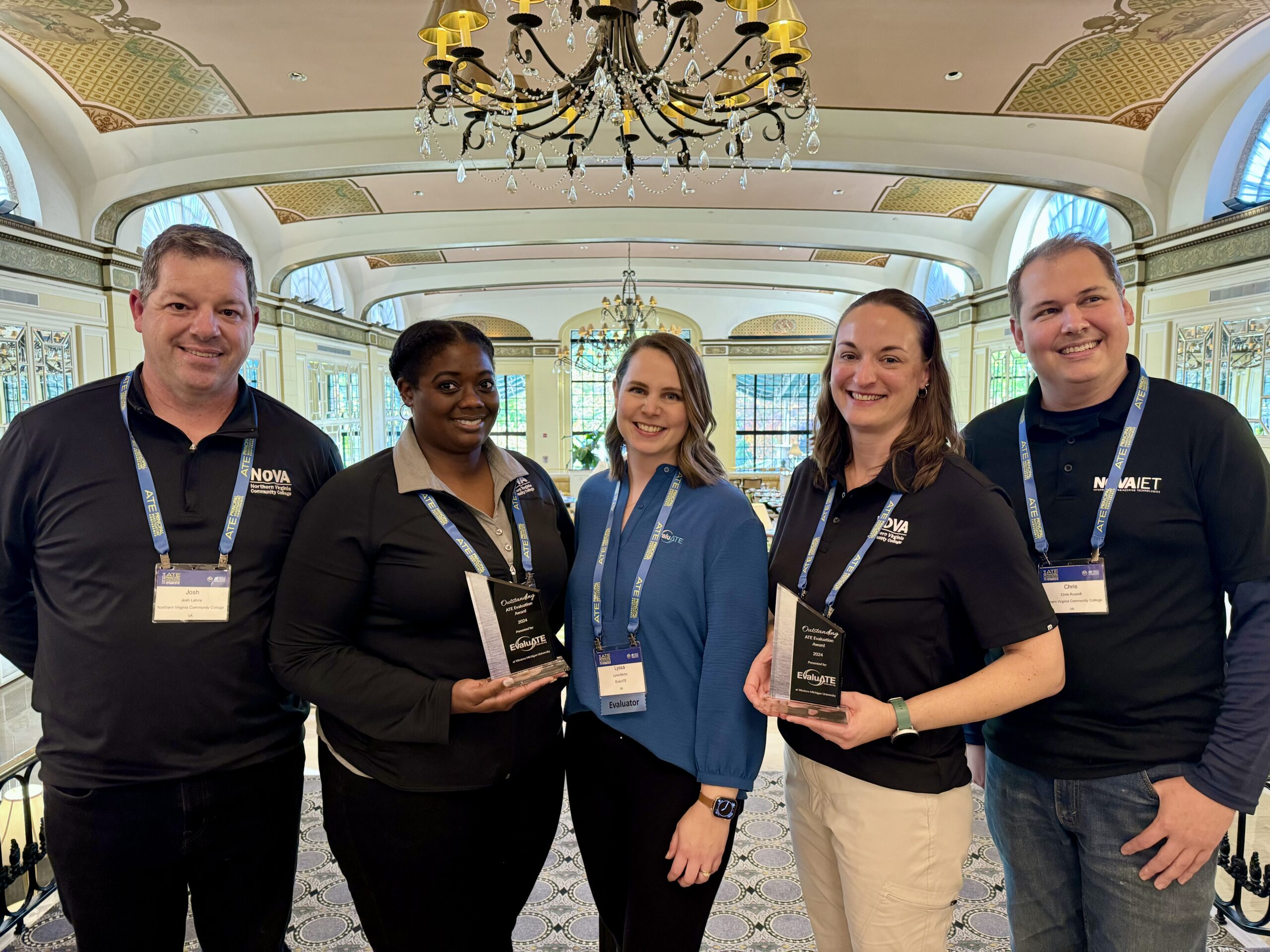 Project team holding their awards with EvaluATE PI Lyssa Wilson Becho
