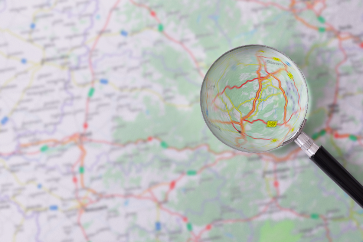 Road map with magnifiying glass on top